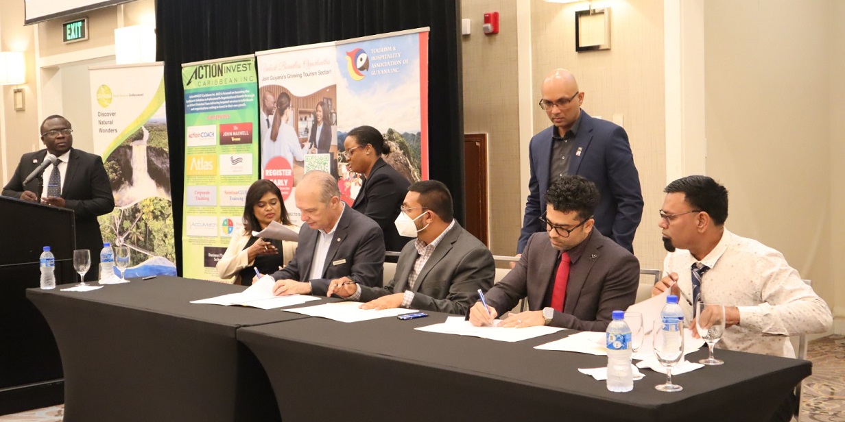 Signing of the MoU at the ActionInvest Caribbean inaugural ceremony/CTH launch event. Included in the image are representatives from Marriott, Ramada, GTA, THAG.