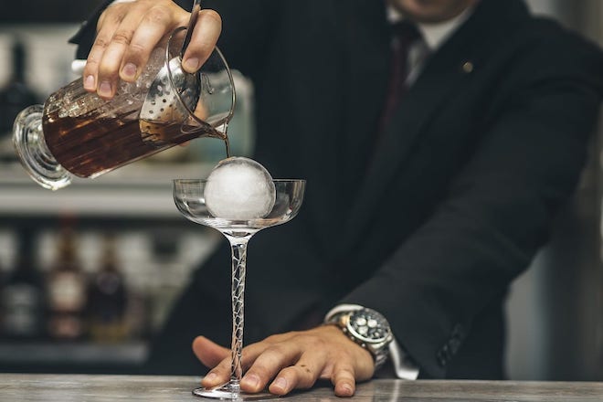 An image of a male bartender pouring a cocktail at the Mirror Bar in The Landmark Hotel (The Landmark Hotel is a CTH Gold Employer).