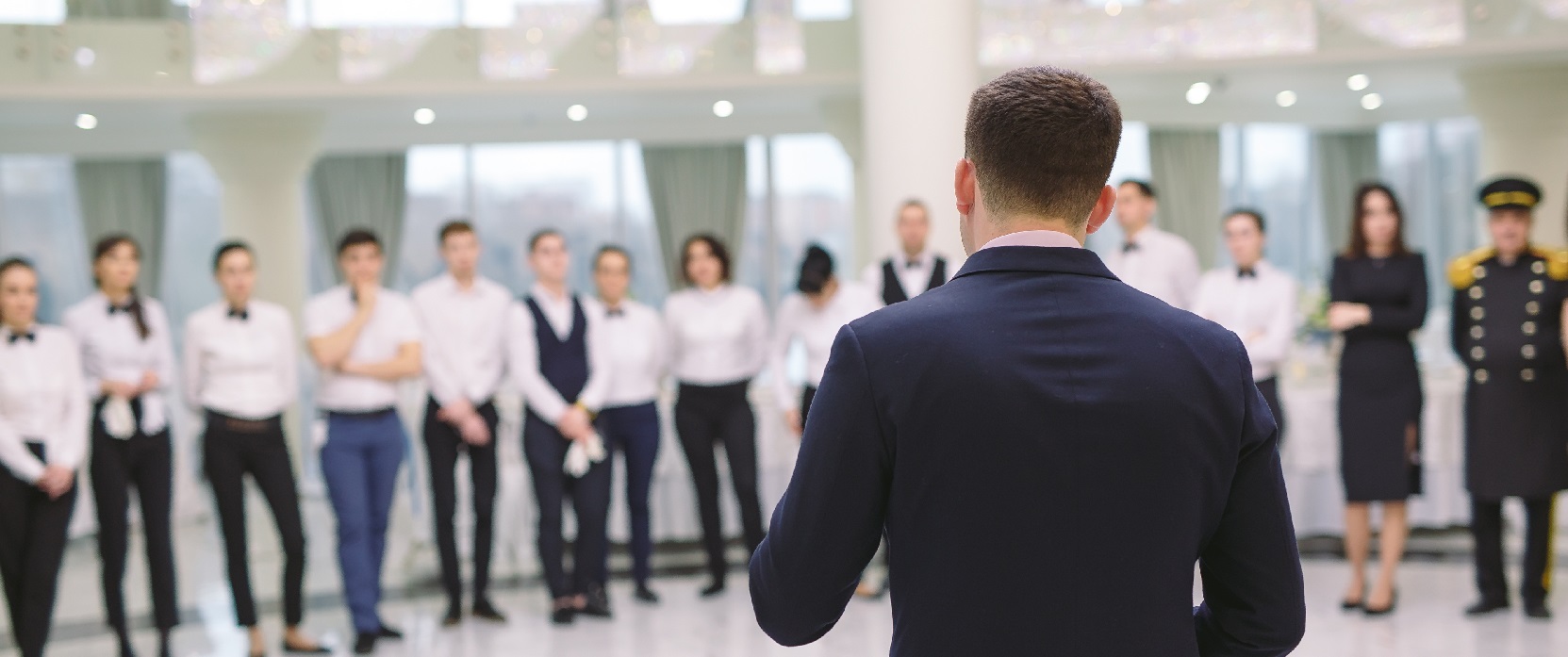 An image of a manager heading a team briefing full of hotel and restaurant staff members. This image is being used as the cover image for the CTH Gold Employers page.