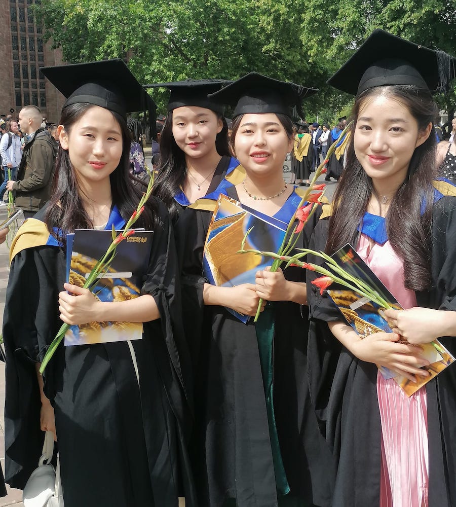 A group of Korean girl students from CU Coventry posing on their graduation day.