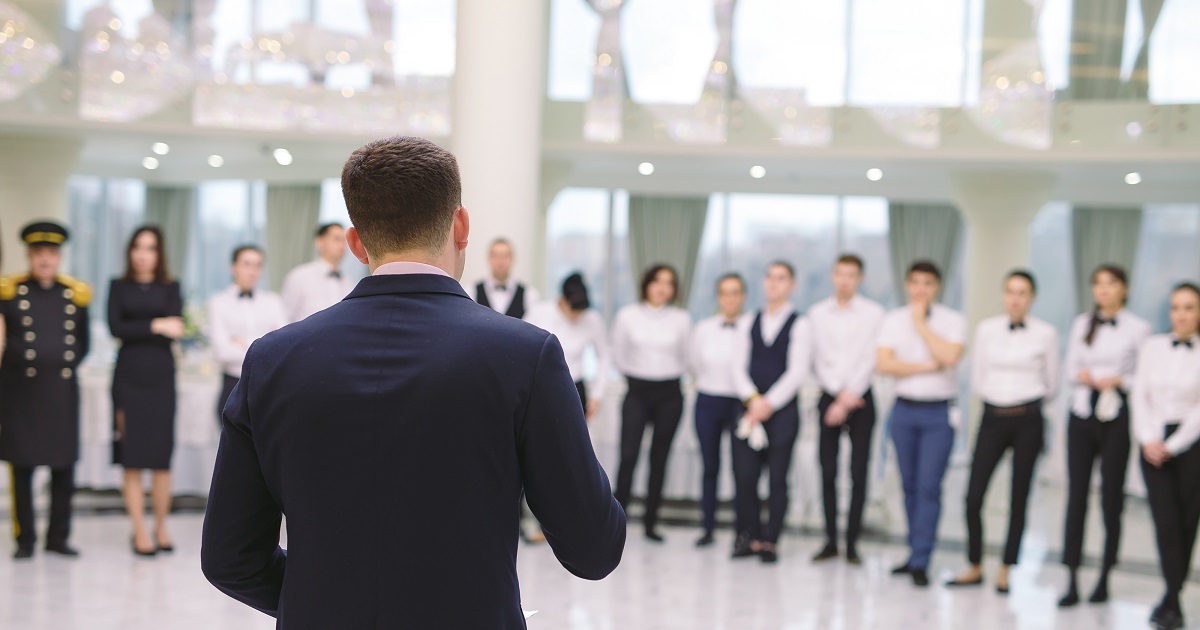An image of a manager heading a team briefing full of hotel and restaurant staff members. This image is being used as the cover image for the CTH Gold Employers news article.